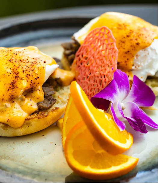 Toas with eggs and orange slices.