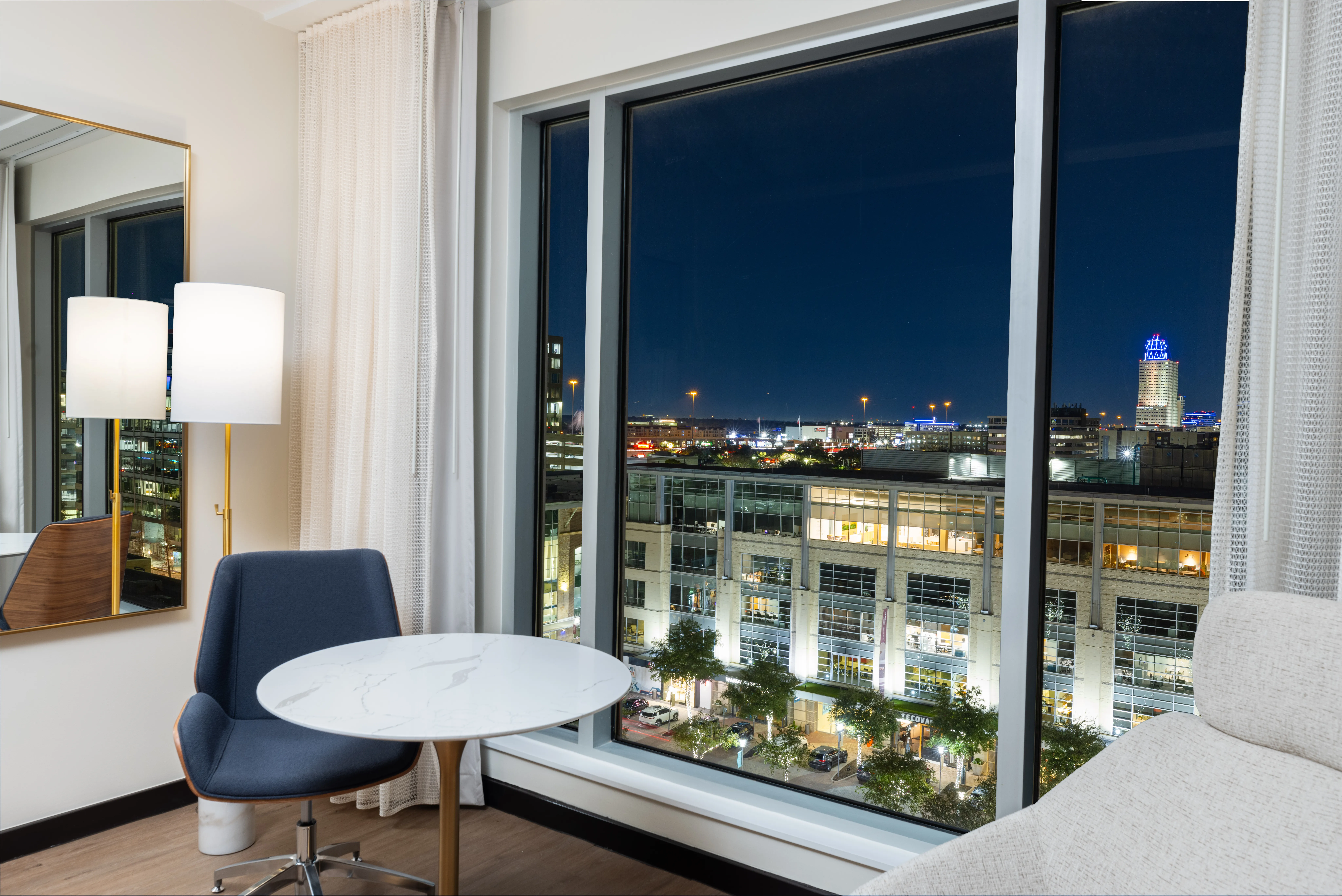 Chair and table with night city view.