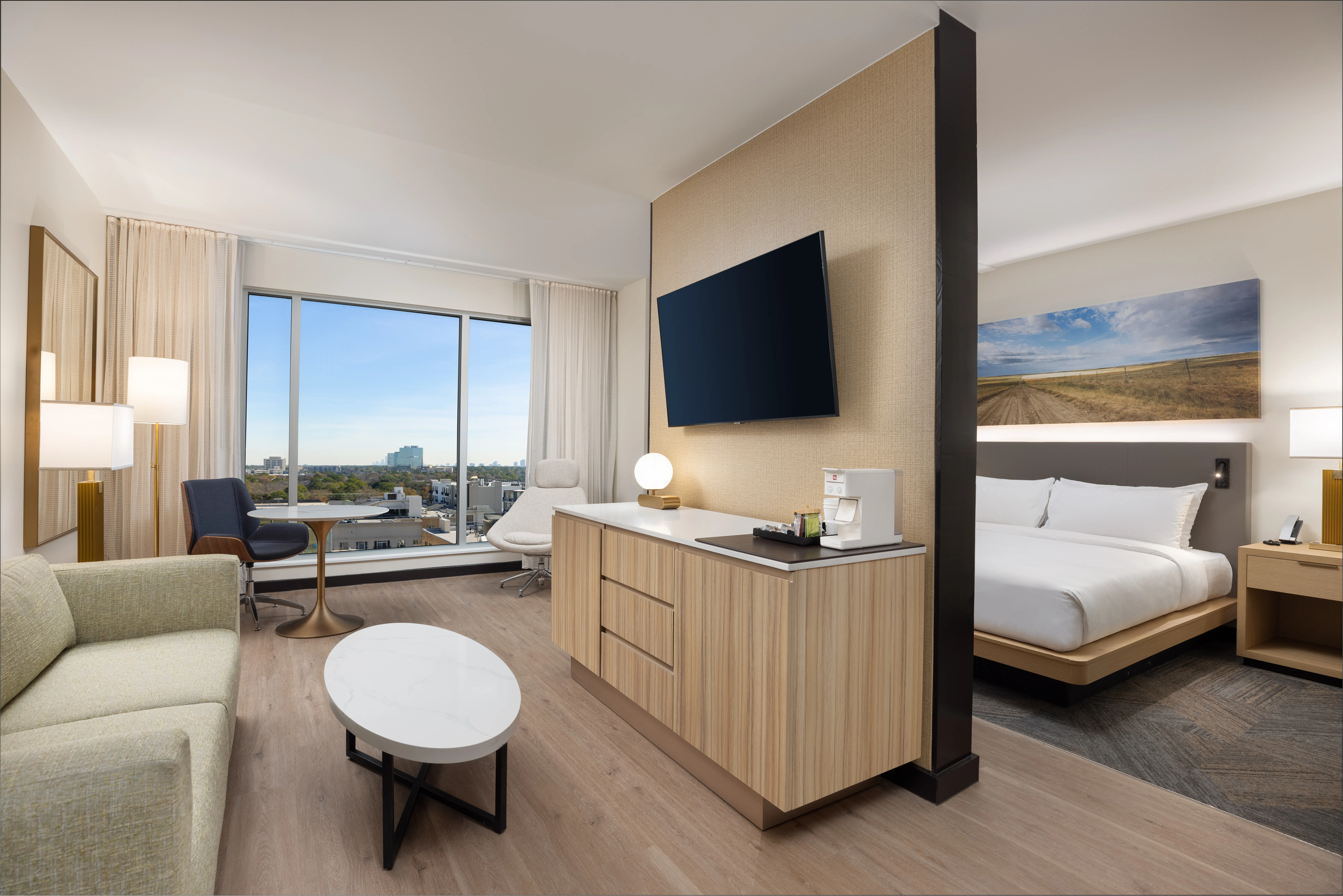 Corner hotel room with large windows.