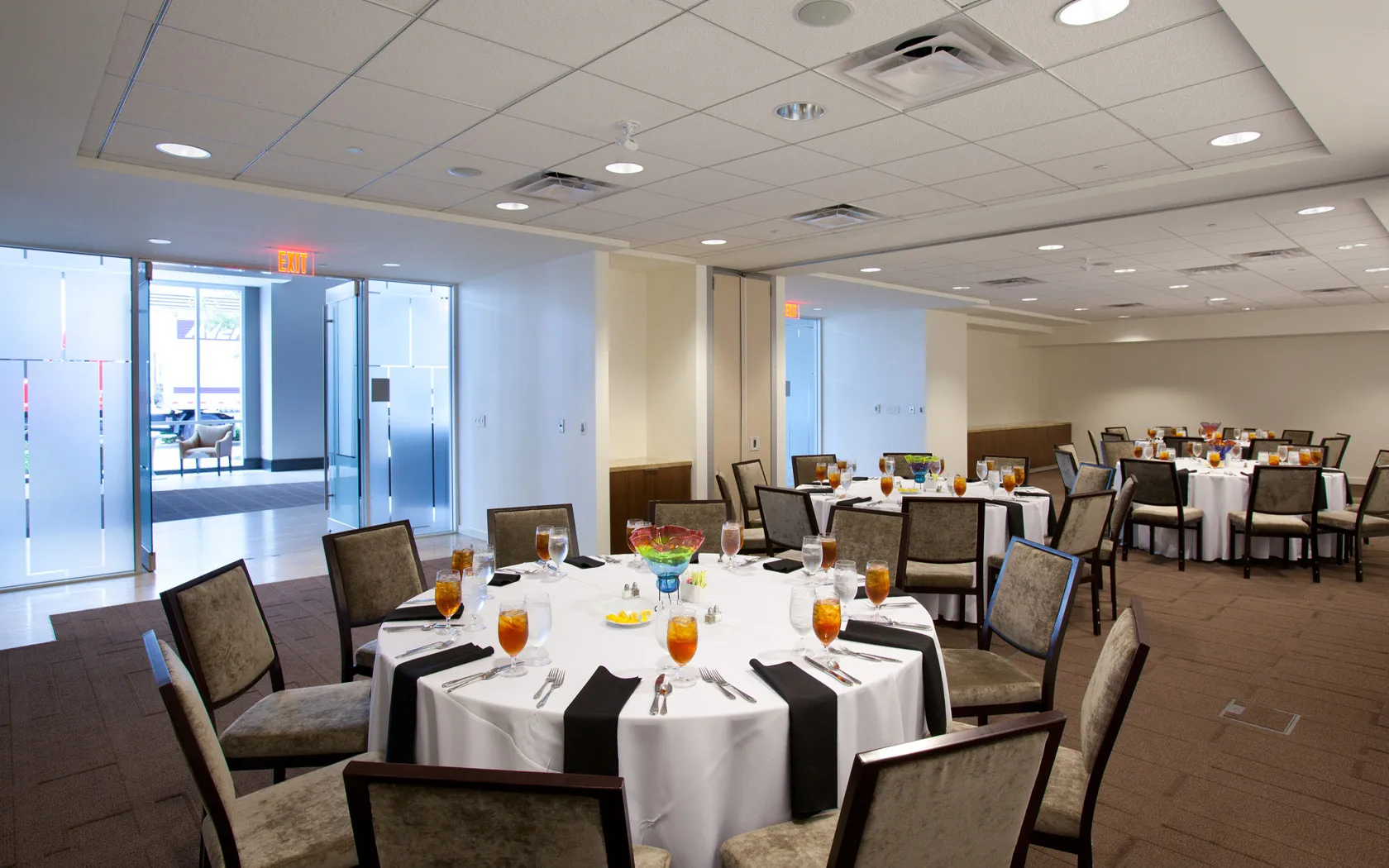 Event space with round tables and white linens.